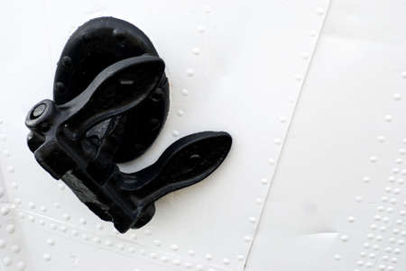 closeup of a black anchor on a white boatの写真素材