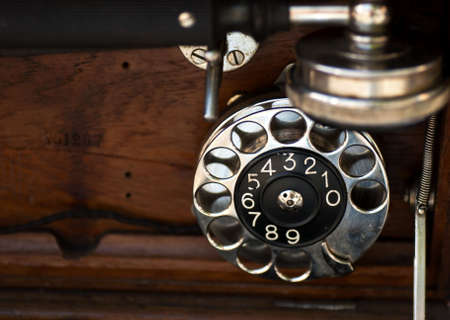 Dialer and wood details of an old phoneの写真素材