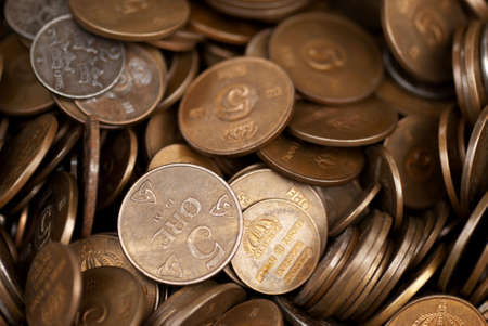 A collection of brass coins from different countriesの写真素材