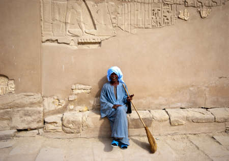 Luxor , Egypt, Jan 13th, 2011. A staff member having a cigarette break, Last year 14.7 million tourists visited Egypt, Tourism in Egypt makes up about 11 percent of the gross domestic product and has been hit hard by the recent unrest in the country.のeditorial素材