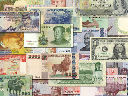 banknotes from different countries overlapping each otherの写真素材