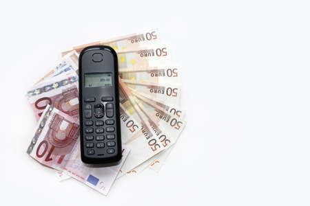 Wireless telephone on banknotesの写真素材