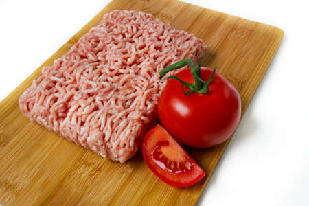 minced meat on a wooden cutting boardの写真素材