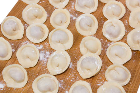 Russian pelmeni on a cutting boardの写真素材