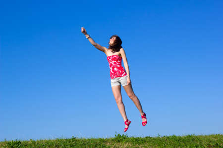 beautiful young woman is flying up の写真素材
