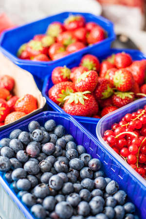 Fresh strawberries, currants and blueberries in bowlsの写真素材