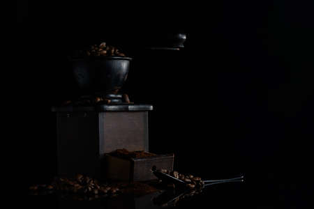manual coffee grinder coffee beans black backgroundの写真素材