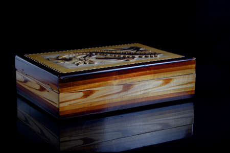 old wooden carved casket on a black backgroundの写真素材