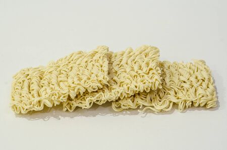 Three raw insant noodles on top of each otherの写真素材