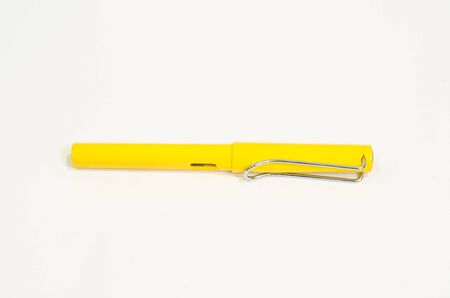 A yellow plastic ballpen on white backgroundの写真素材