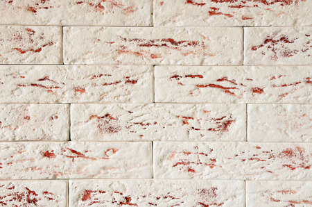 A fragment of the wall made of plaster decorative bricks, without seams.