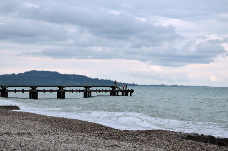 View of the Black sea, waves and pebble beach in cloudy weather.の写真素材