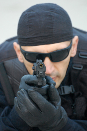 The security man aim at us with gun.の写真素材
