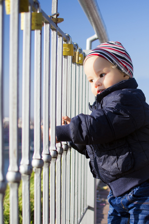 The little child is looking through the lattice fence.の写真素材