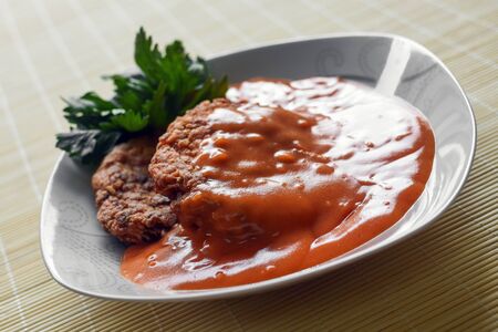 Meatballs in tomato sauce is in white plate on natural background.の写真素材