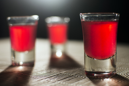 Three glasses of red alcohol are on the table.の写真素材
