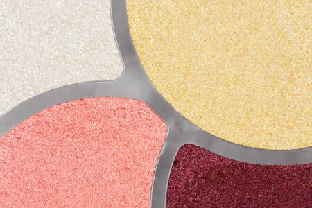 Close-up photo about four different colors of eye shadows.