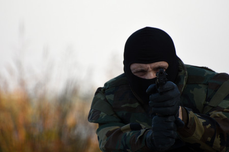 The soldier is shooting with gun outdoor.の写真素材