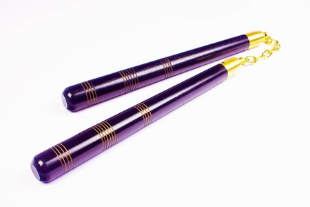 Purple nunchaku, the asian weapon isolated on white background.の写真素材