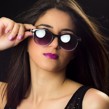 Fashion portrait about a pretty young woman with sunglasses.の写真素材
