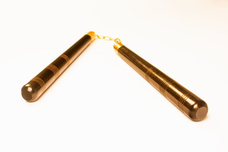 Bronze nunchaku, the asian weapon is isolated on white background.の写真素材