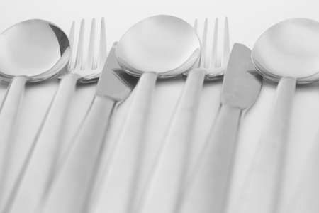Spoons, forks and knifes are on white background.の写真素材