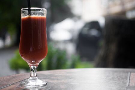Smoothie from red fruits on the table.