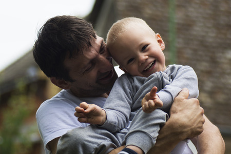 Boy and his uncle are laughing and enjoying together.の写真素材
