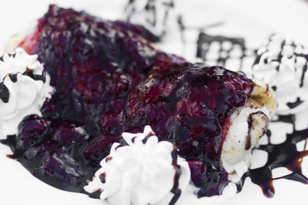 Pancake with cherry sauce and whipped cream.の写真素材