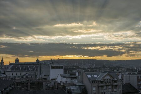 Budapest city landscape with cloudy sky at sunset.