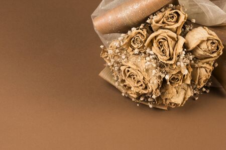 Dried wedding bouquet of roses on brown background.の写真素材