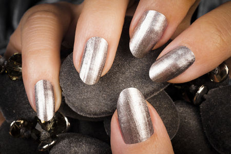 Female hand with silver gray nails, manicure concept.の写真素材