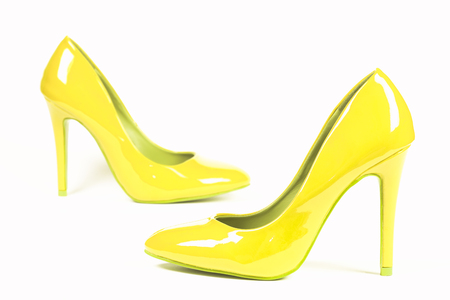 Sexy yellow lacquer shoes high heels are on white background.の写真素材