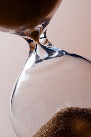 Close-up photo of sand clock with leaking sand.
