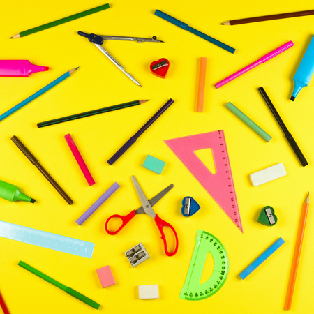 Different school supplies are on yellow background.の写真素材