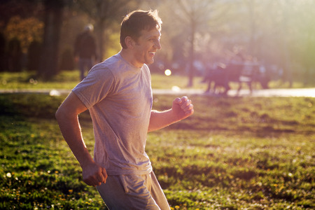 The smiling active man is in the park outdoors.の写真素材