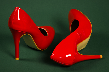 Red high heels shoes are on dark background.の写真素材
