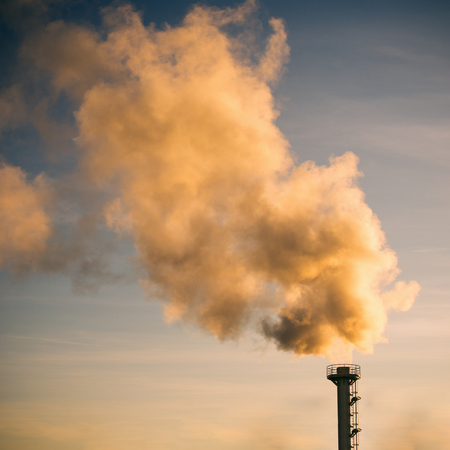 The smoke is flying on the sky from chimney of factory, damaged environment concept.