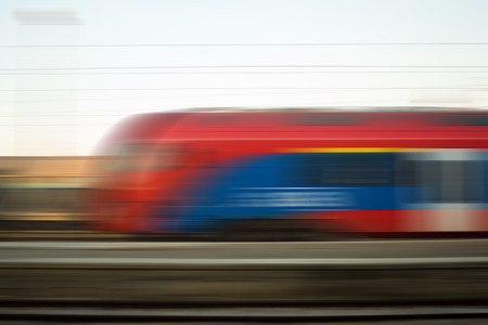 Blurred motion of express train vehicle on railway, high speed concept.