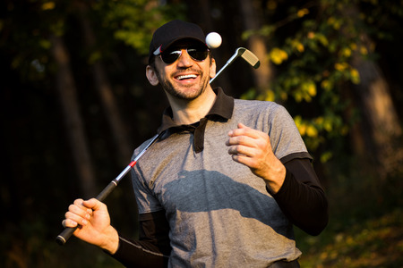 Portrait of cheerful smiling playful golfer or golf player.