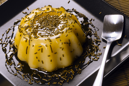 Banana pudding sweet dessert is on black square plate on table.の写真素材