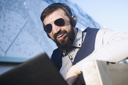 The virtual assistant or financial advisor with earphones and microphone is working online on...