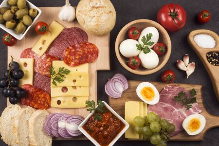 Delicious gourmet appetizer or breakfast in restaurant or smorgasbord with meat, cheese, tomato and...