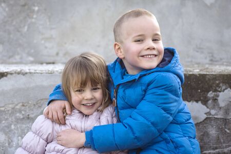 The little sister and the big brother are together, cute smiling children.