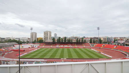 Serbia/Novi Sad - June 12, 2020: Empty football stadium or soccer stadium in Novi Sad in Serbia on cloudy sky background.のeditorial素材