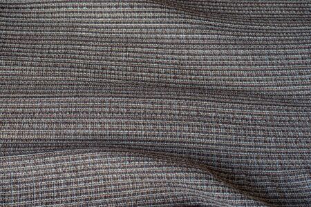 Perspective and close-up view of the abstract space of the brown fabric texture with repetitive...