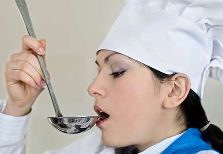 The cook tries meal from a spoon の写真素材