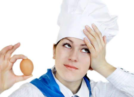 Young surprised woman in chef hatの写真素材
