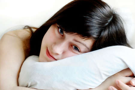 Young sleeping woman in bed の写真素材