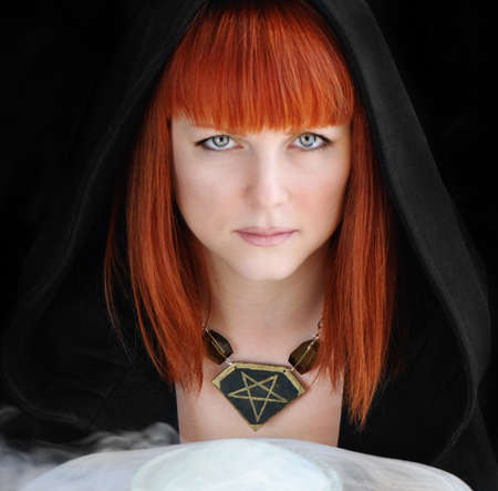 Beautiful sad woman in a hood の写真素材